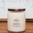 Jar candle with a brown lid on a wooden surface, featuring Farmhouse Candle Company 'Roost Mercantile' branding.