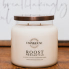 Farmhouse Candle Company jar candle Roost Mercantile with a bronze lid on a wooden surface.
