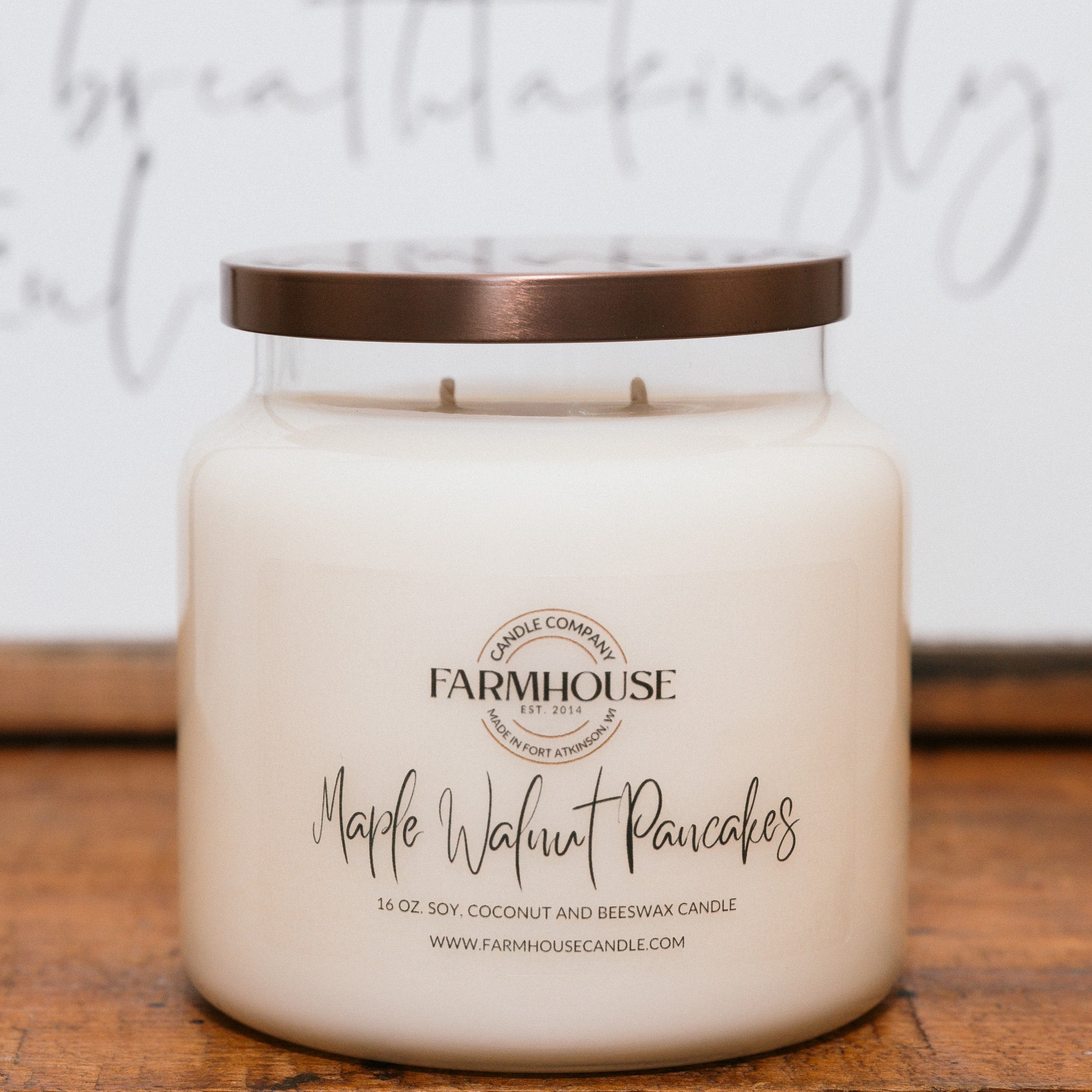 Farmhouse Candle Company jar candle with 'Maple Walnut Pancakes' scent on a wooden surface.