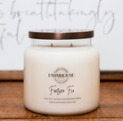 Farmhouse Candle Company 'Frasier Fir' scented soy, coconut and beeswax candle in a clear glass jar with a bronze lid.